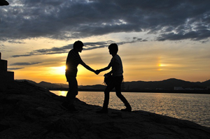 Two young men shaking hands. Meant to illustrate good conduct of Godly believers.