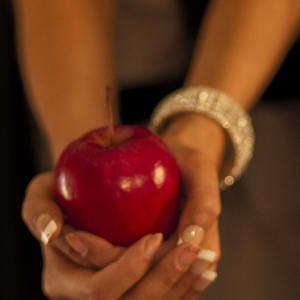 Seductive hands holding an apple. Meant to illustrate sin