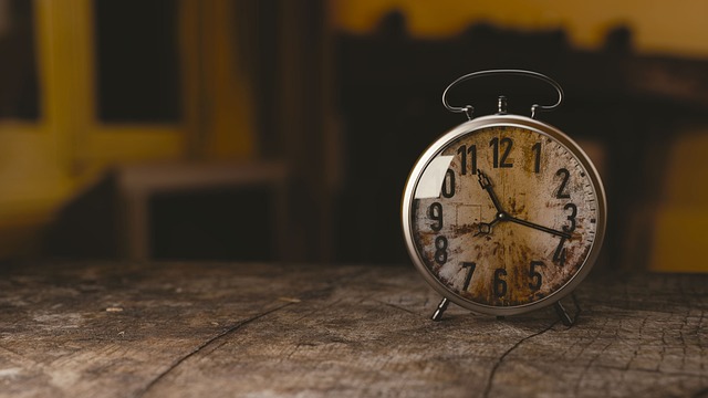 Picture of an old winding clock on a table. Meant to illustrate that transformation in life takes time.